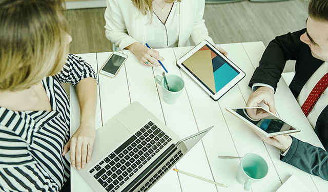 Pessoas em mesa de escritório tendo uma reunião